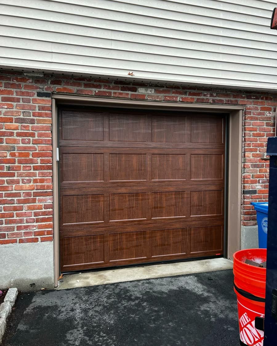 Wood look garage door on a red brick garage