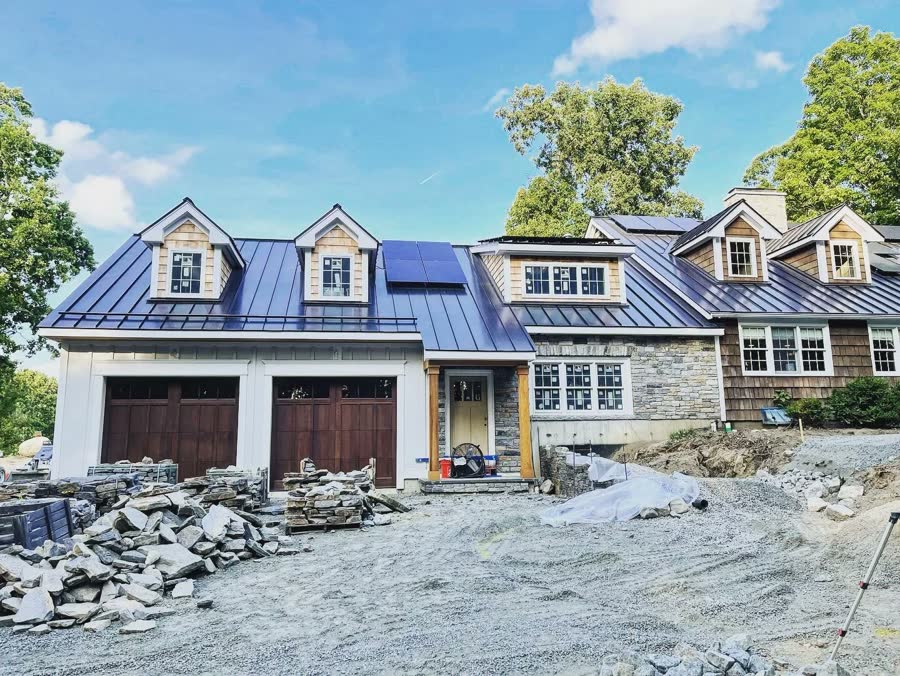 Three carriage doors on a new build with a metal roof